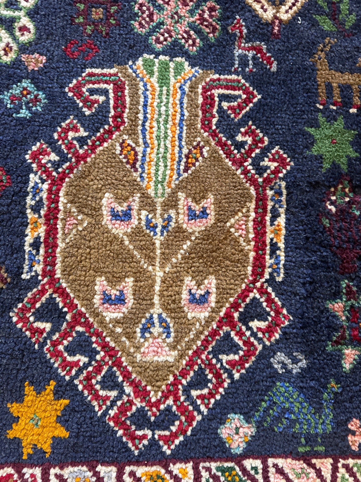 Colourful tribal Persian rug muted colours