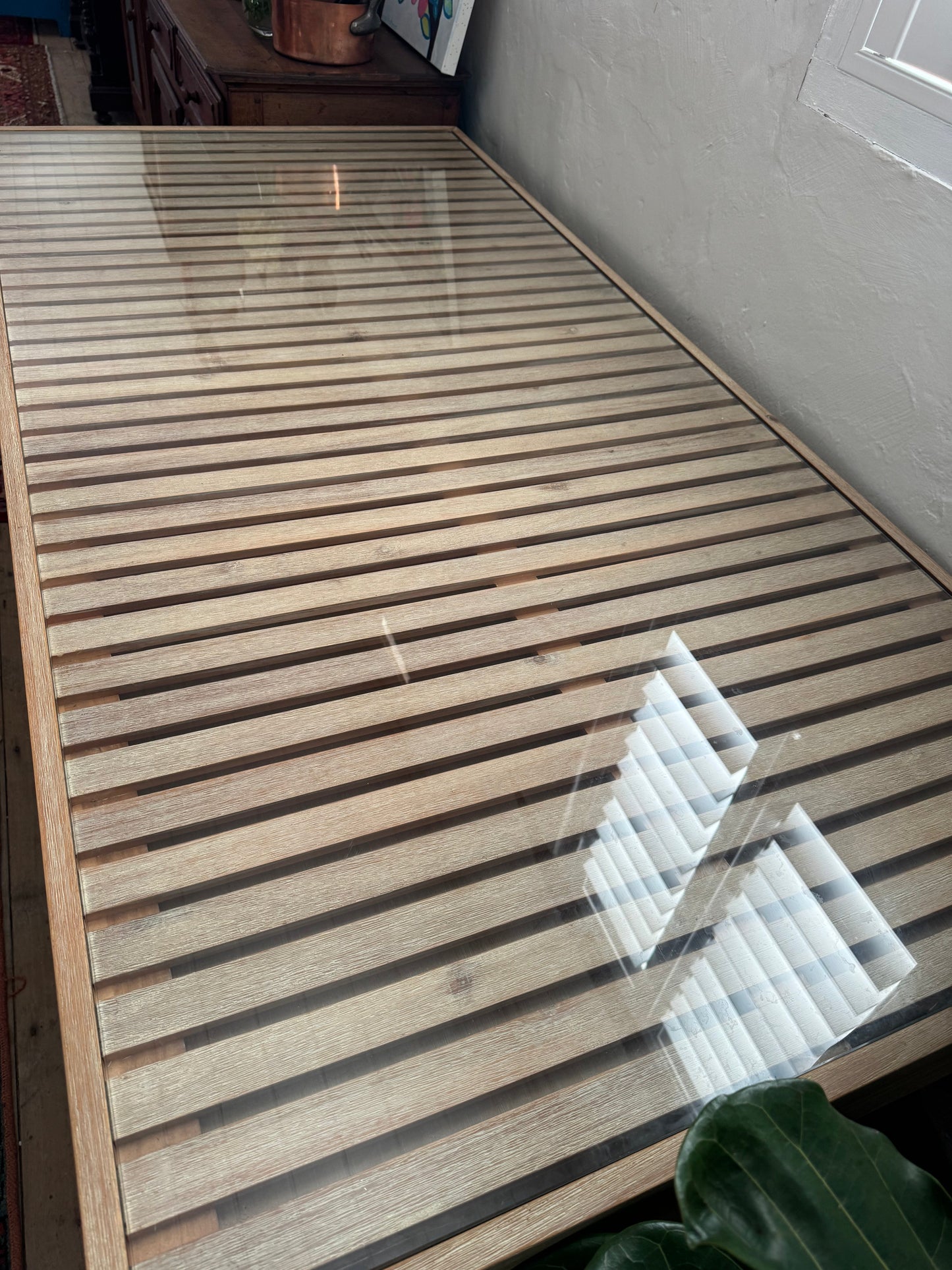 Glass topped table on castors