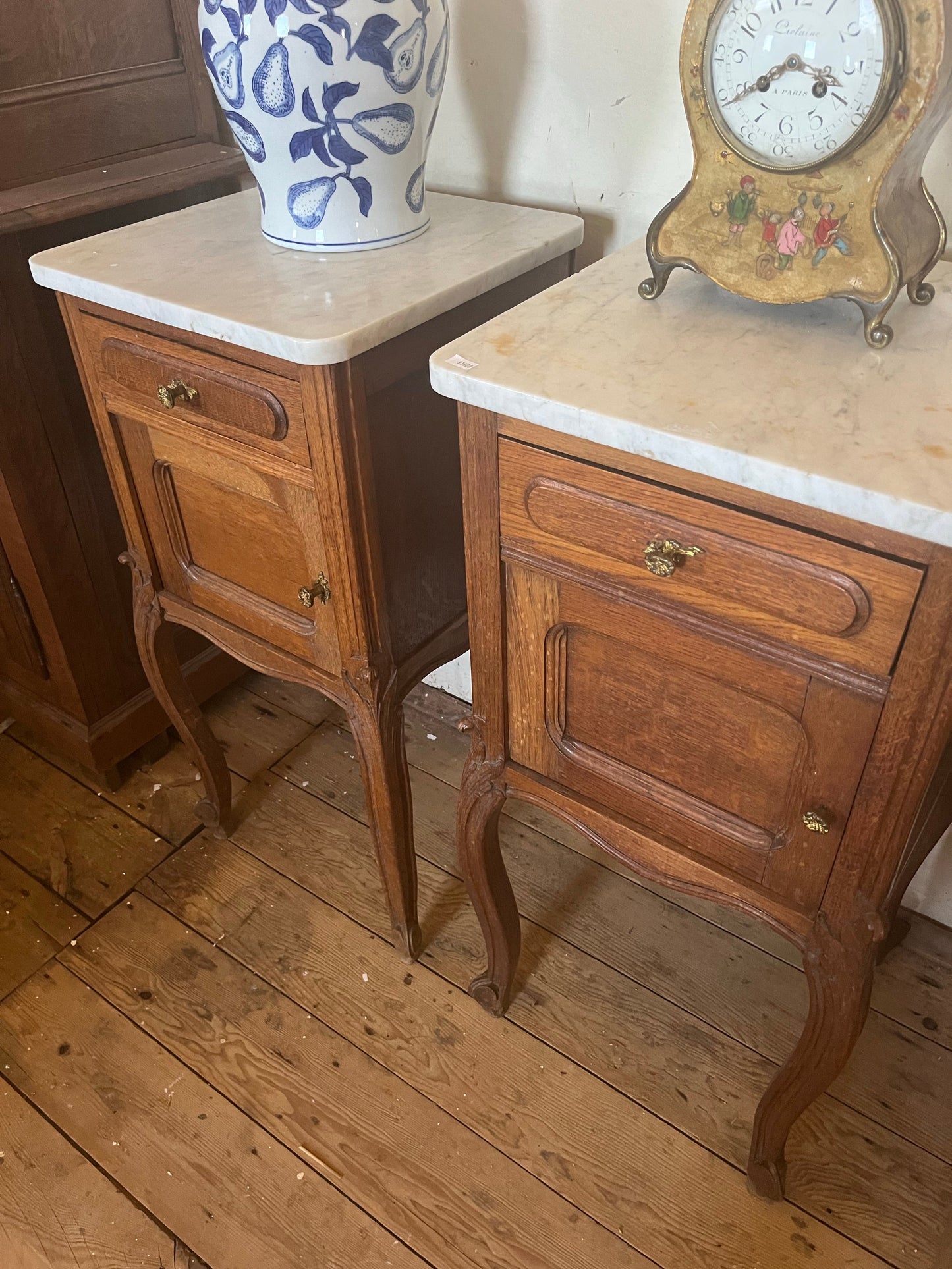 A pair of Antique oak marble topped bedside cabinets