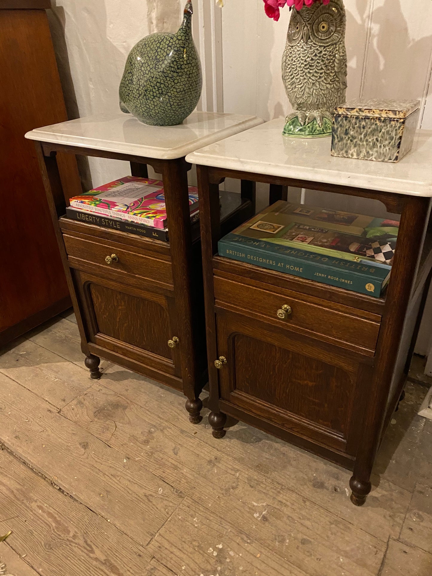 A pair of French oak marble topped bedsides