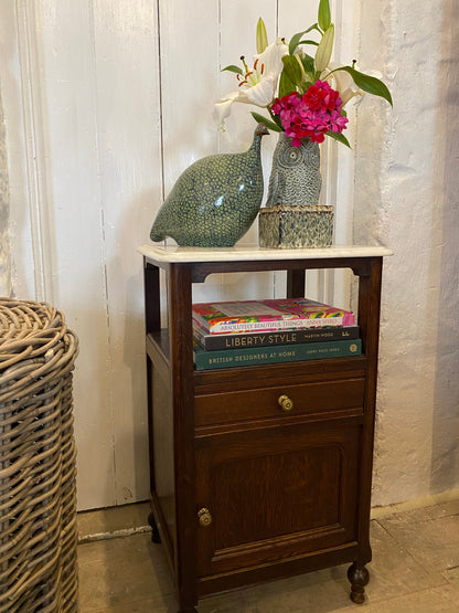 A pair of French oak marble topped bedsides