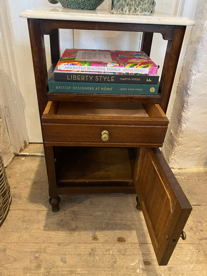 A pair of French oak marble topped bedsides