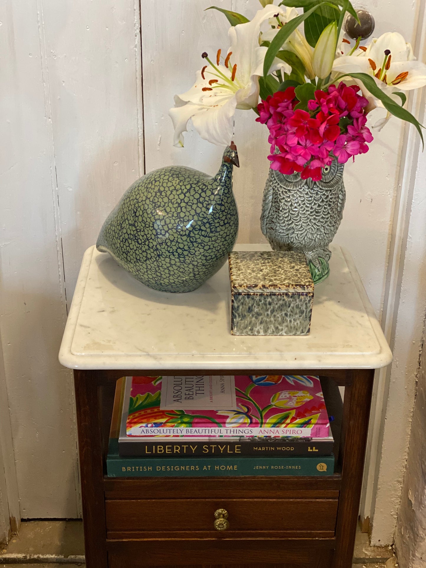 A pair of French oak marble topped bedsides