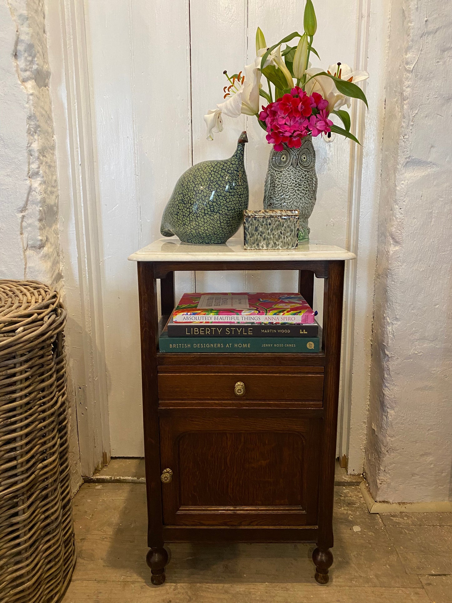 A pair of French oak marble topped bedsides