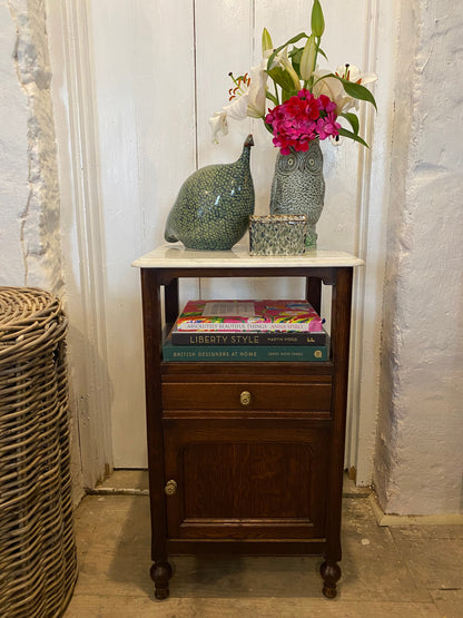 A pair of French oak marble topped bedsides