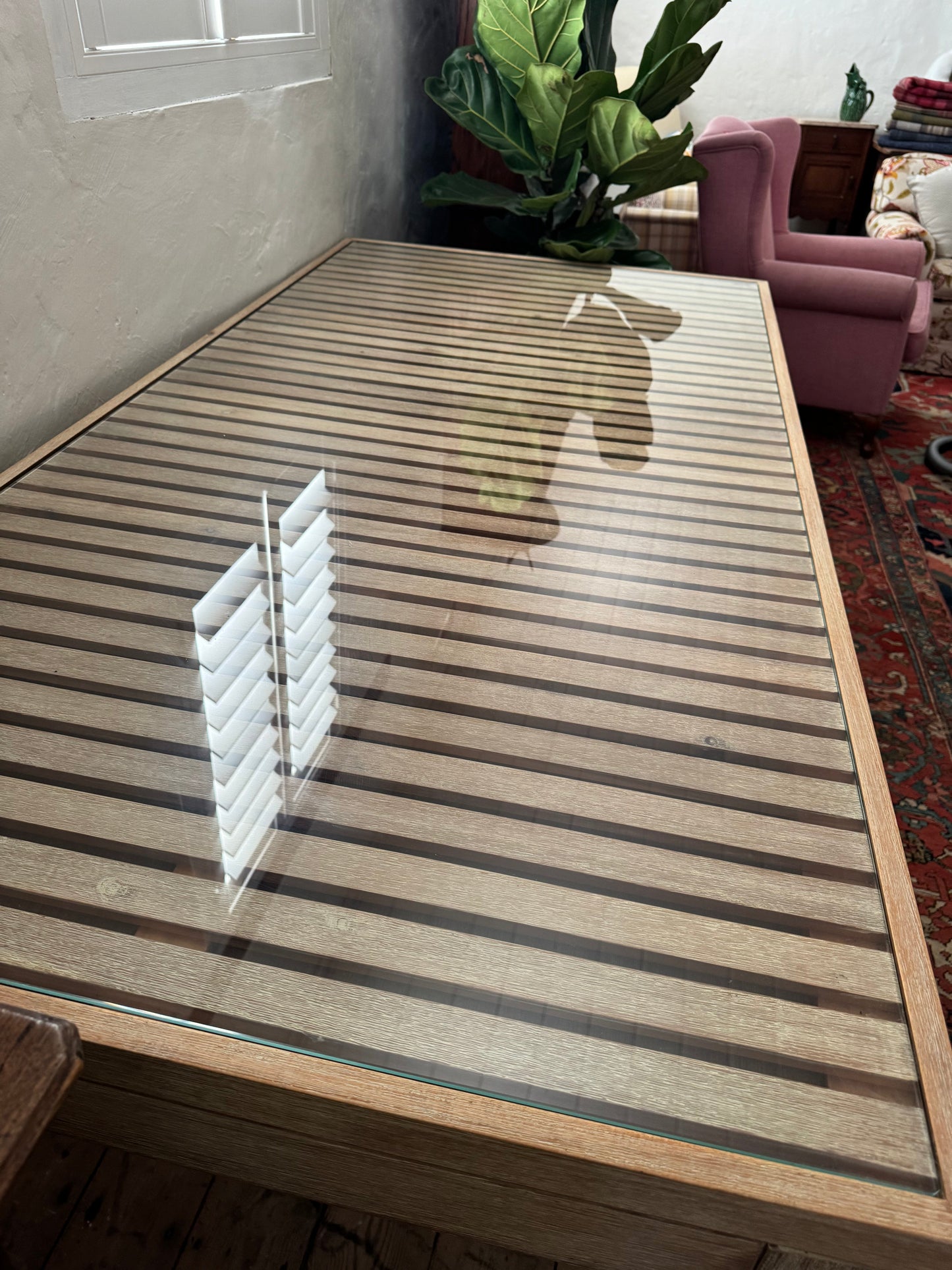 Glass topped table on castors