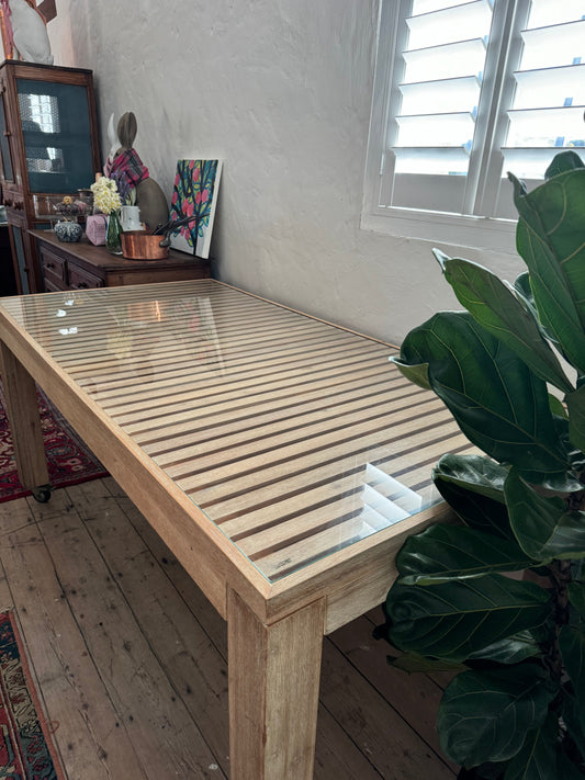 Glass topped table on castors