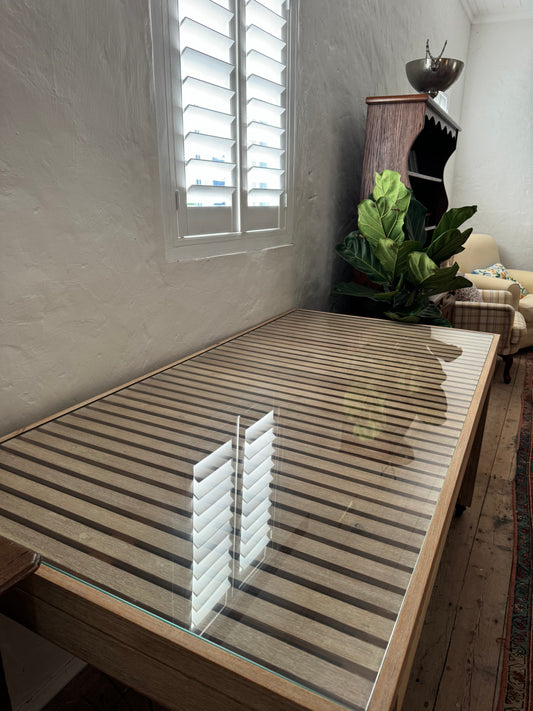 Glass topped table on castors