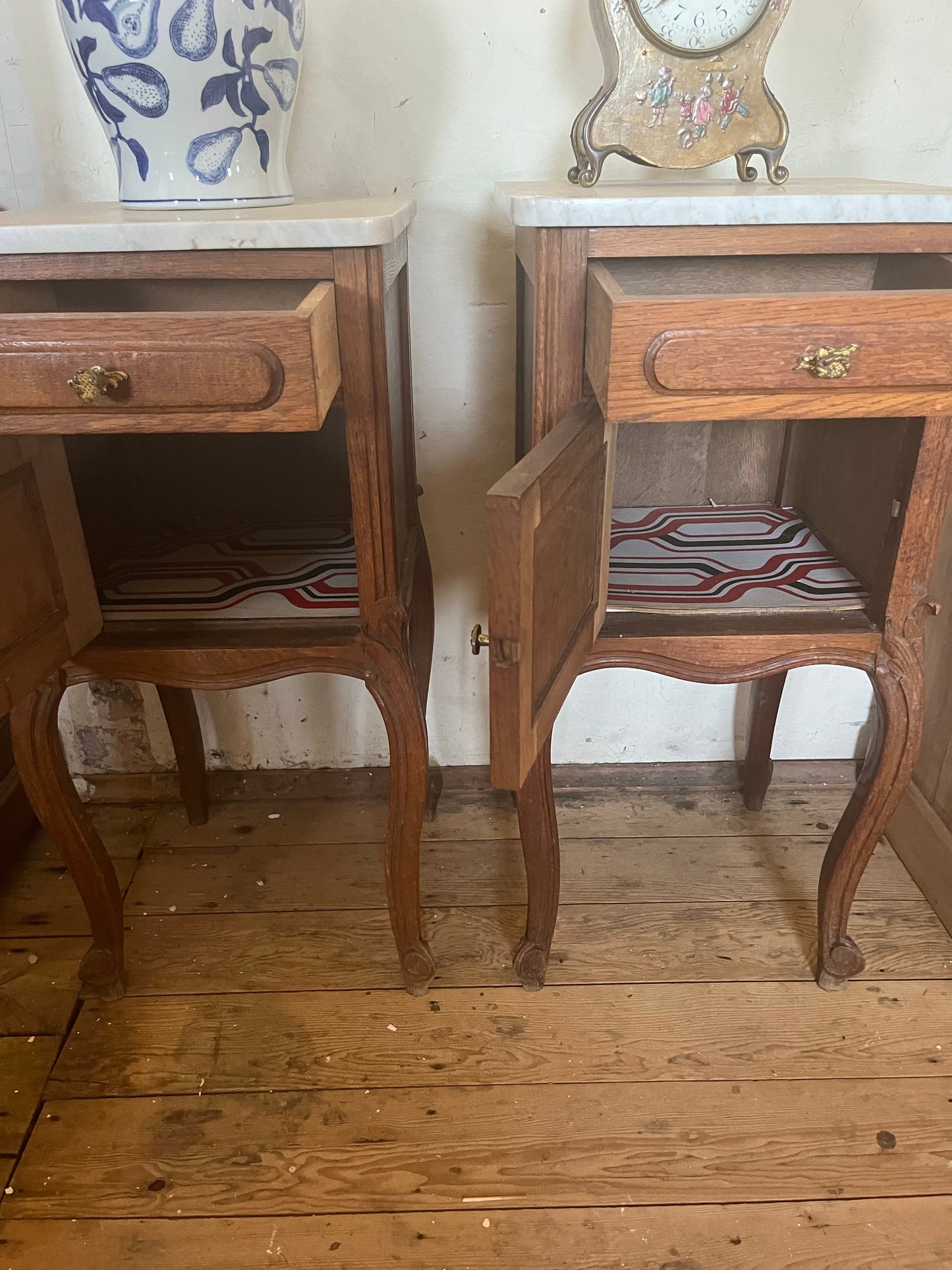 A pair of Antique oak marble topped bedside cabinets