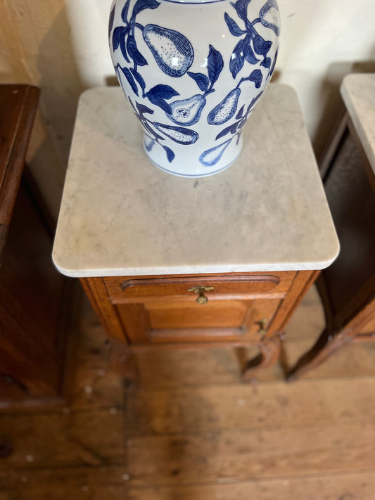 A pair of Antique oak marble topped bedside cabinets