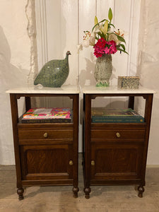 A pair of French oak marble topped bedsides